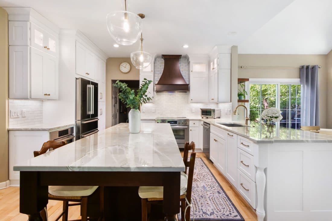 Bright white kitchen with a polished marble island